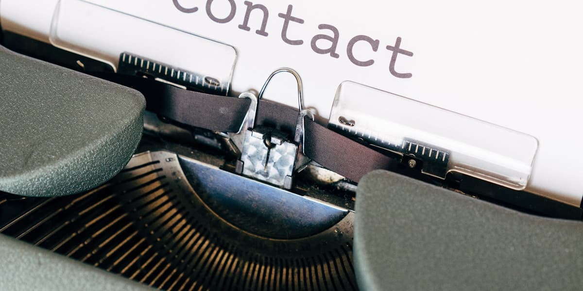 Vintage typewriter with contact typed on the page