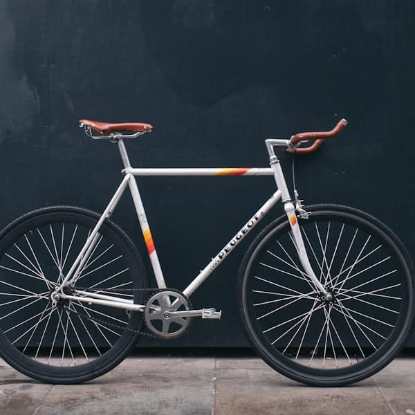 A bicycle leaning against a curb